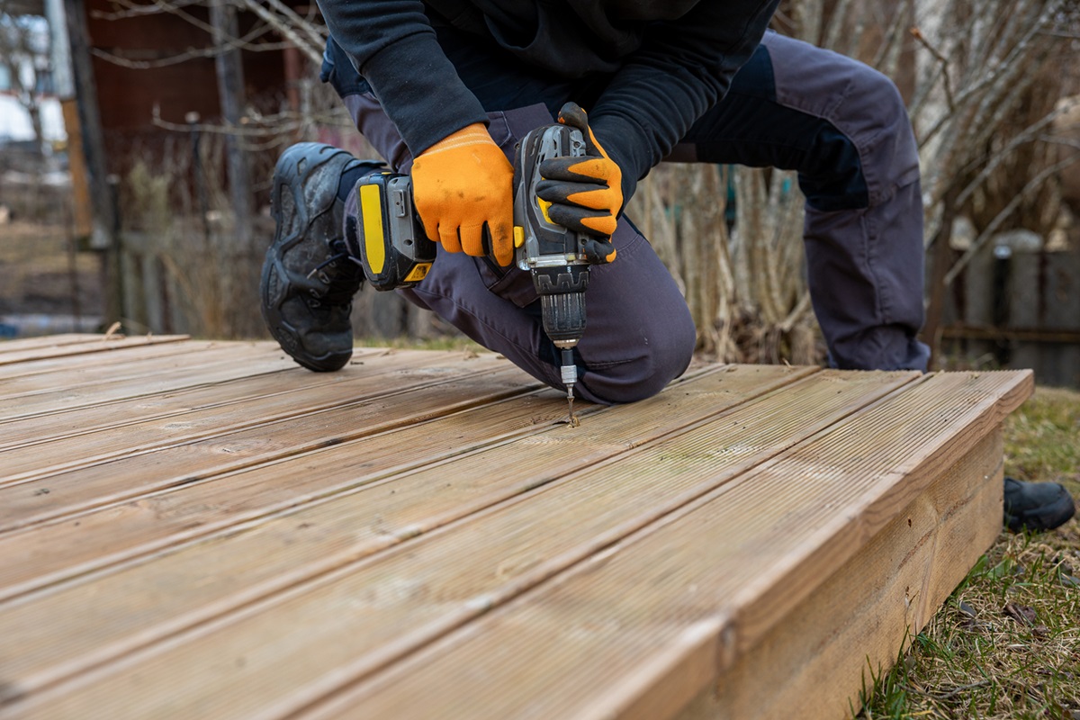 https://www.fastenere.com/blog-assets//man%20with%20yellow%20gloves%20drilling%20into%20wooden%20decking_1742976993.jpg